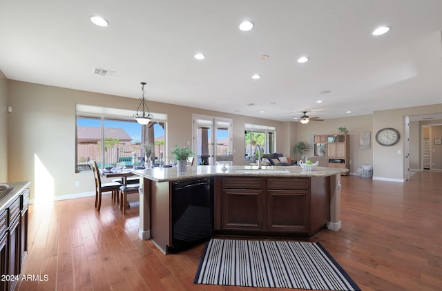 kitchen featuring hardwood / wood-style floors, sink, an island with sink, and decorative light fixtures