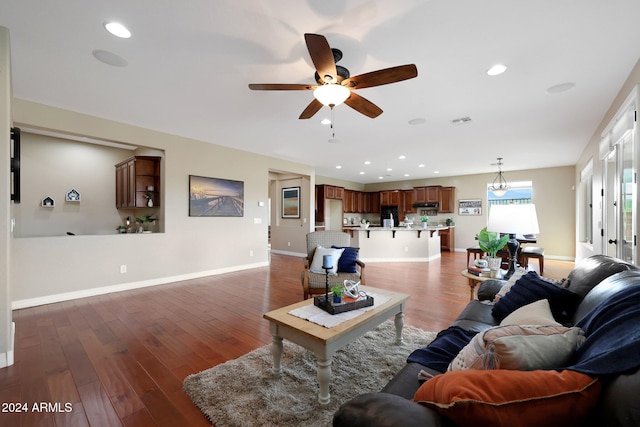 living room with ceiling fan and dark hardwood / wood-style floors