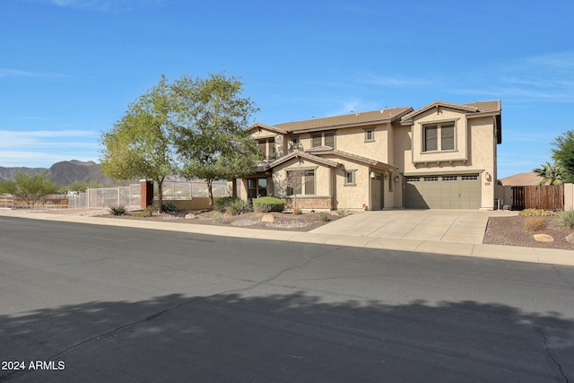 view of front of property featuring a mountain view and a garage