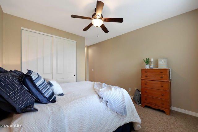 bedroom with a ceiling fan, baseboards, light colored carpet, and a closet