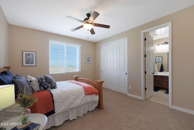 bedroom featuring ensuite bath, light carpet, a closet, and ceiling fan