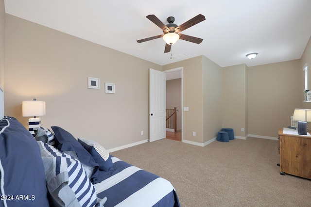 carpeted bedroom with baseboards and a ceiling fan