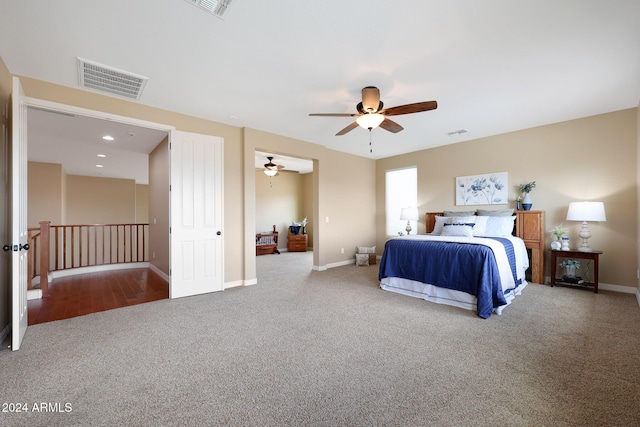 carpeted bedroom featuring baseboards, ceiling fan, and visible vents