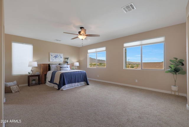 bedroom featuring visible vents, a ceiling fan, carpet, and baseboards