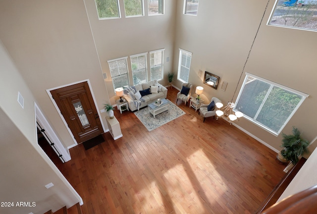 unfurnished living room with hardwood / wood-style floors and a high ceiling