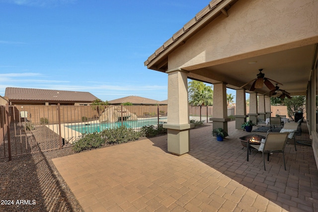 view of patio / terrace featuring ceiling fan and a fenced in pool