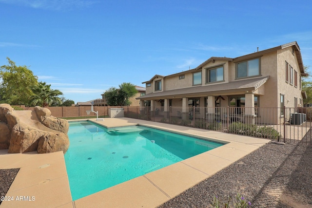view of swimming pool featuring a fenced in pool, a patio, central AC unit, and a fenced backyard