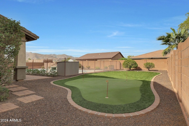 view of yard with a fenced backyard and a mountain view