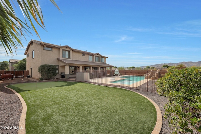 view of swimming pool with a fenced in pool, a patio, a mountain view, and a fenced backyard