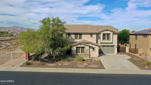 view of front facade featuring fence, a garage, stucco siding, concrete driveway, and a tiled roof