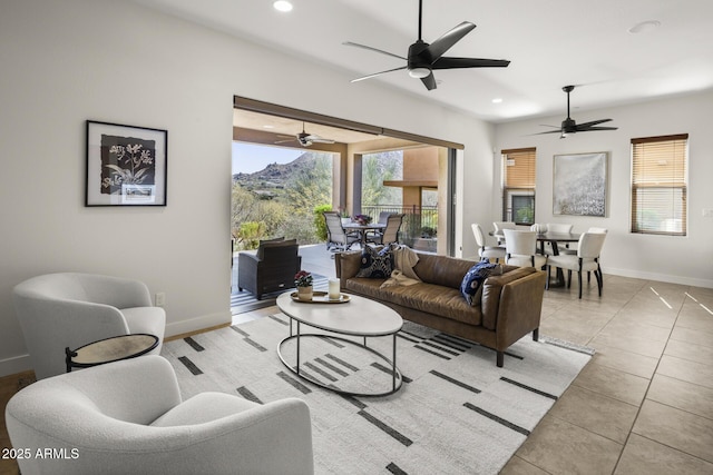 living area with baseboards, light tile patterned floors, and recessed lighting