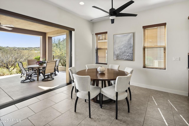 dining room with ceiling fan, tile patterned floors, and baseboards