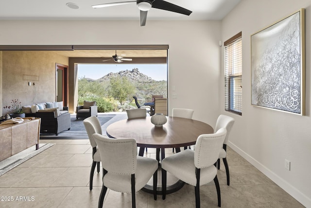 dining room with a ceiling fan, baseboards, a wealth of natural light, and light tile patterned flooring