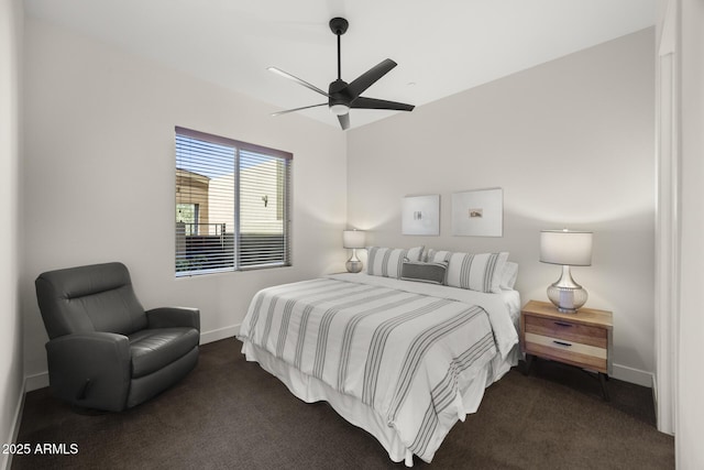 bedroom with ceiling fan, dark carpet, and baseboards