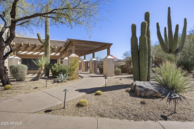 view of yard with fence and a pergola