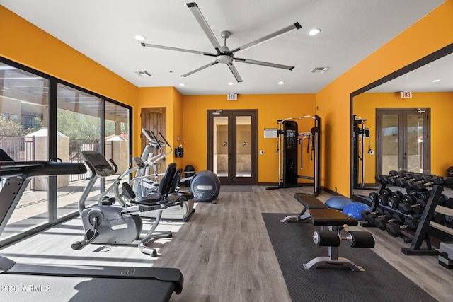 workout area featuring recessed lighting, visible vents, wood finished floors, and french doors