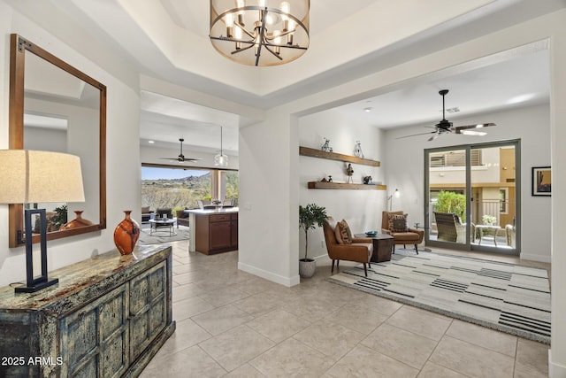 interior space featuring light tile patterned floors, baseboards, and an inviting chandelier