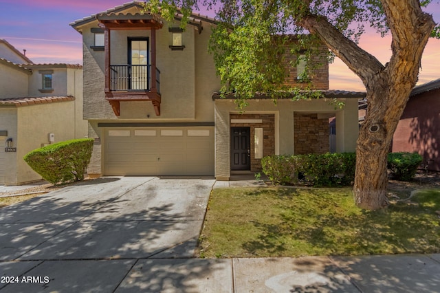 mediterranean / spanish-style house featuring a tiled roof, stucco siding, a garage, stone siding, and driveway