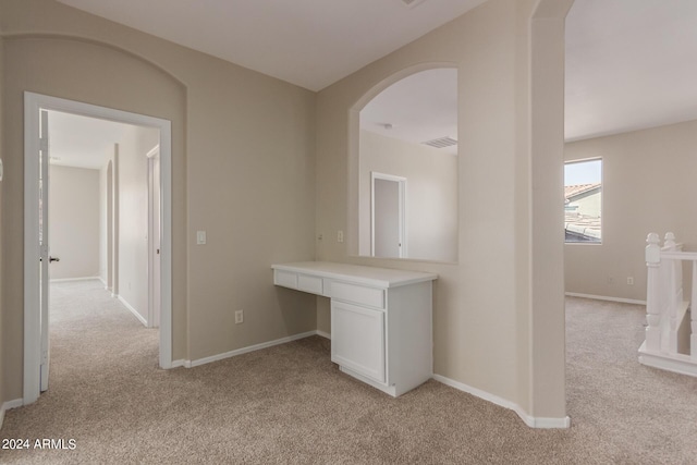 hall featuring visible vents, light colored carpet, and baseboards