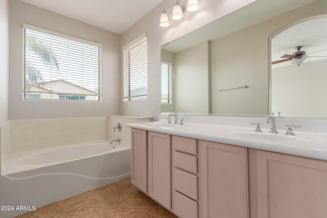 bathroom featuring a sink, plenty of natural light, a bath, and tile patterned floors