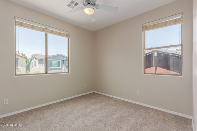 carpeted empty room featuring ceiling fan