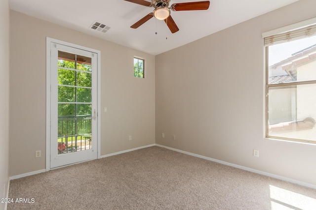 spare room with visible vents, baseboards, ceiling fan, and carpet flooring