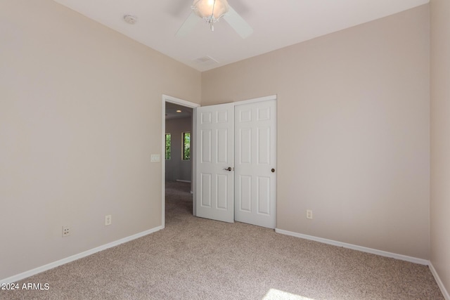 unfurnished bedroom featuring carpet flooring, a ceiling fan, baseboards, and a closet