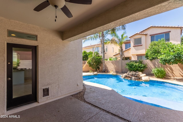 view of swimming pool with a patio area, a fenced backyard, a fenced in pool, and ceiling fan