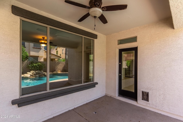 view of patio / terrace with a fenced in pool, ceiling fan, and fence