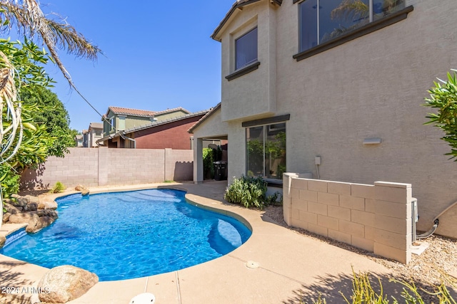 view of swimming pool featuring a patio area, a fenced in pool, and a fenced backyard