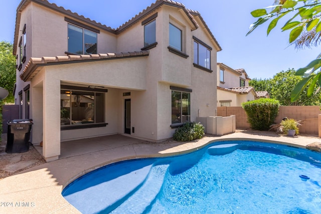 view of swimming pool with a patio area, fence, and a fenced in pool