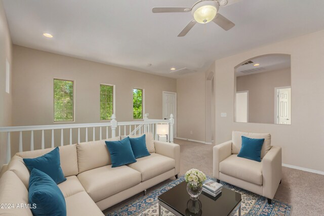 carpeted living room with ceiling fan