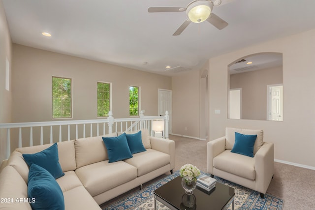 living area with recessed lighting, carpet, arched walkways, and baseboards