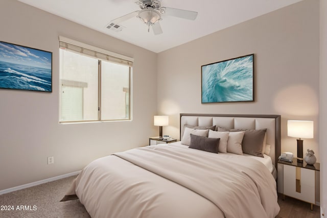 bedroom with visible vents, baseboards, carpet floors, and a ceiling fan