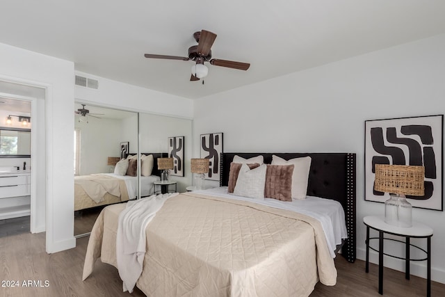 bedroom featuring ceiling fan, a closet, sink, and hardwood / wood-style flooring