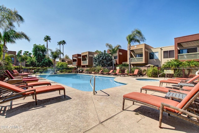 view of pool with a patio area and a community hot tub