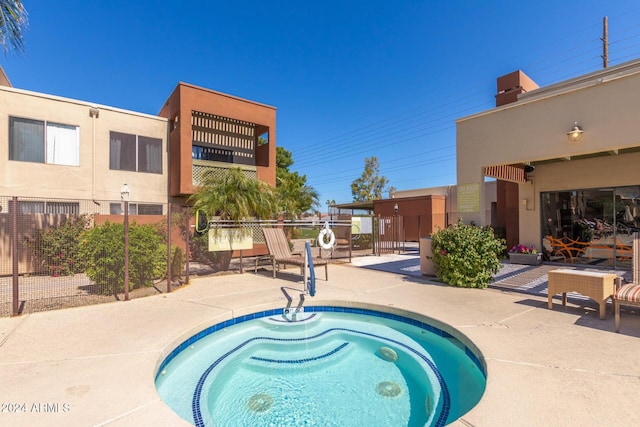 view of pool with a patio area and a hot tub