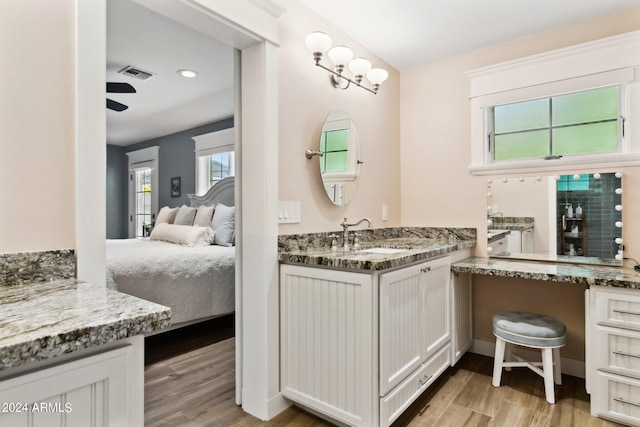 bathroom featuring wood-type flooring, ceiling fan, and sink