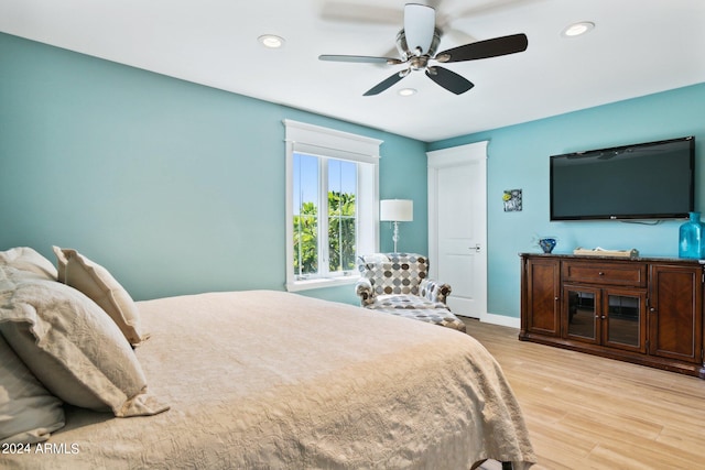 bedroom with ceiling fan and light wood-type flooring