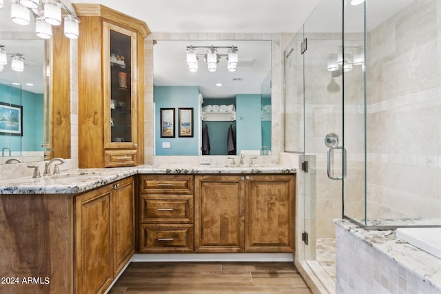 bathroom with vanity, walk in shower, and hardwood / wood-style floors