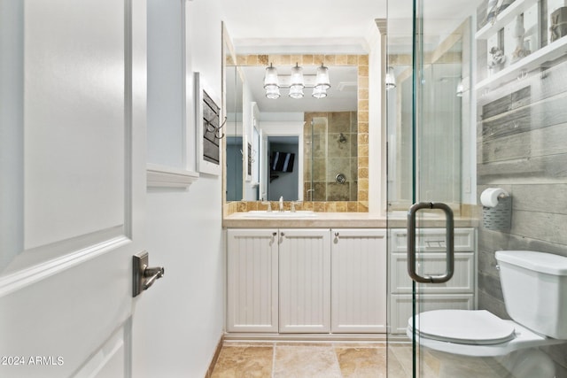 bathroom with vanity, toilet, and a shower with shower door