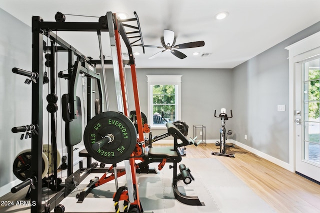 exercise area with ceiling fan and hardwood / wood-style flooring