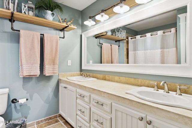 bathroom featuring vanity, toilet, and a shower with shower curtain