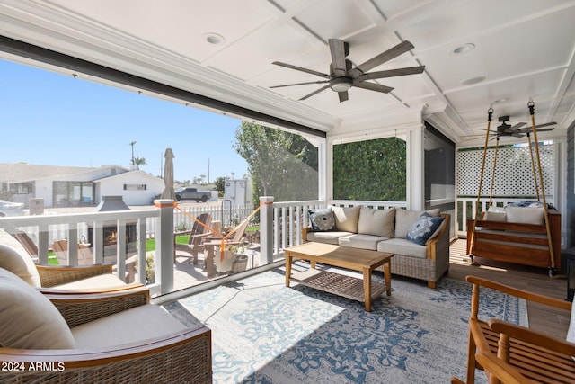 sunroom / solarium featuring coffered ceiling and ceiling fan