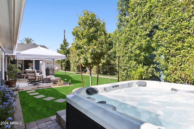 view of yard with a hot tub and a patio