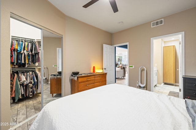 bedroom featuring light wood-style floors, a closet, visible vents, and ceiling fan