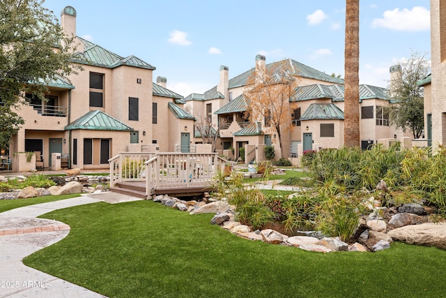 surrounding community with a residential view, a deck, and a yard