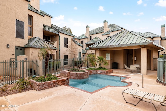 view of swimming pool featuring a patio area, fence, and a fenced in pool