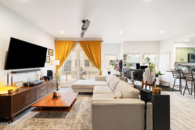 living room with baseboards, a ceiling fan, wood finished floors, and recessed lighting