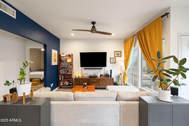 living area with ceiling fan, visible vents, and recessed lighting